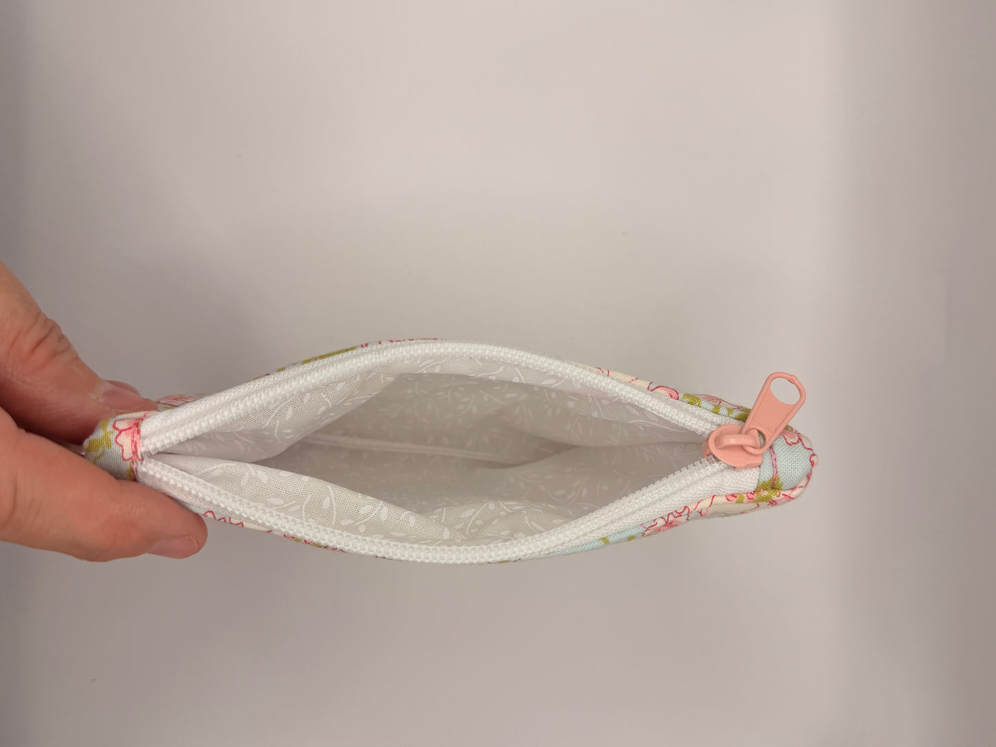 Quilted pink floral-patterned zipper wallet