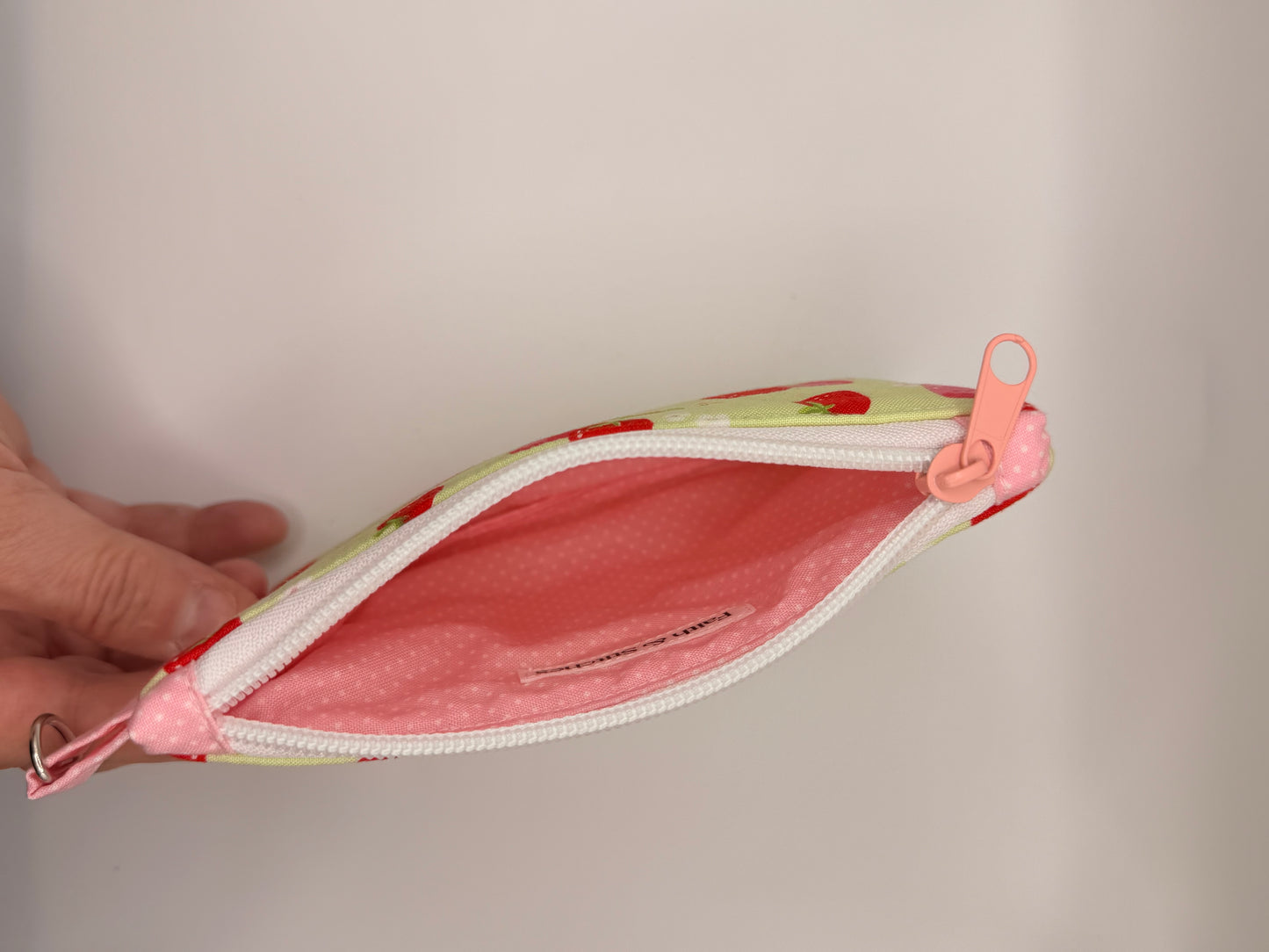 Strawberries and white flowers on green zipper wallet